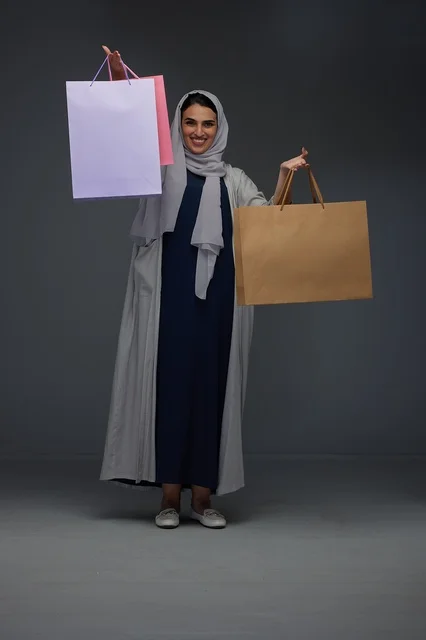 Saudi Woman Holding Shopping Bags in Studio