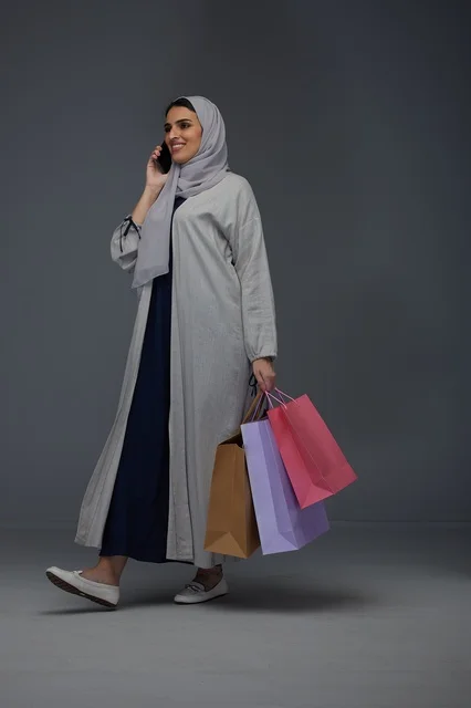 Saudi Woman with Shopping Bags Talking on Smartphone