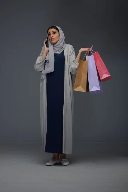 Saudi Woman Shopping While Talking on Smartphone