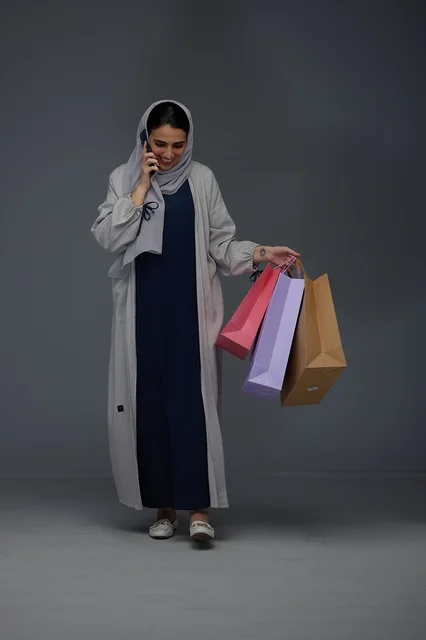 Saudi Woman Shopping with Colorful Bags and Smartphone