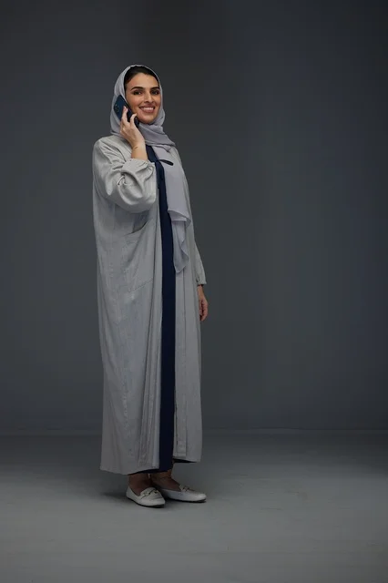 Saudi Woman Talking on Smartphone in Abaya