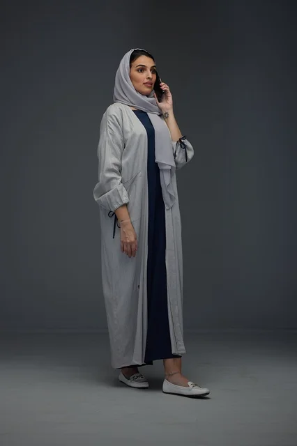 Saudi Woman in Grey Abaya Talking on Phone in Studio