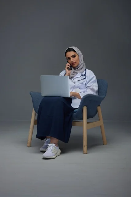 Saudi Female Doctor with Laptop and Smartphone