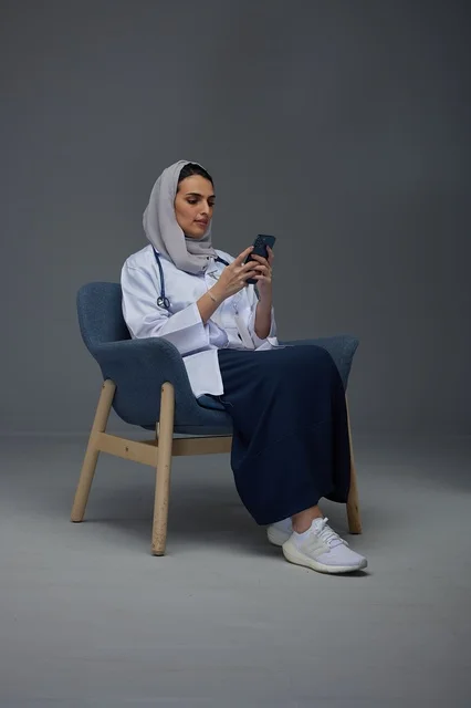 Saudi Female Doctor Using Smartphone in Studio Saudi Female Doctor Using Smartphone in Studio