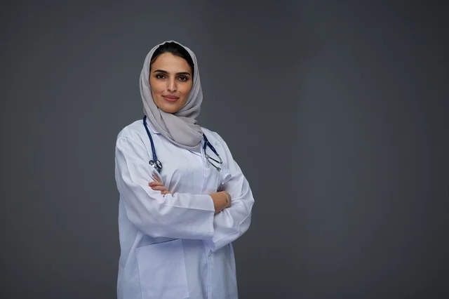 Smiling Saudi Female Doctor in White Lab Coat
