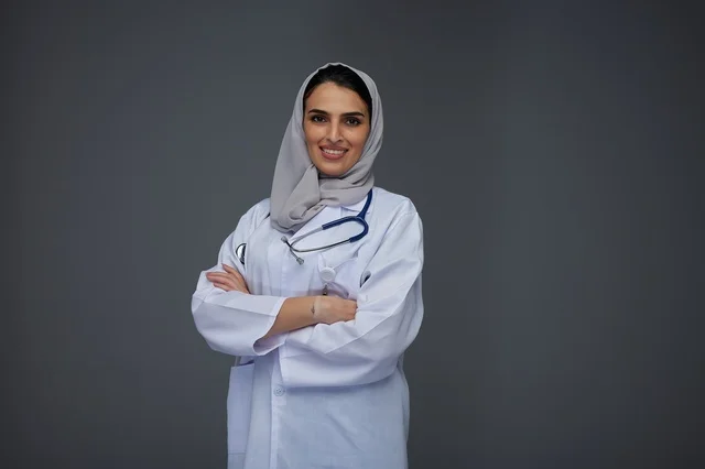 Smiling Saudi Female Doctor in White Lab Coat