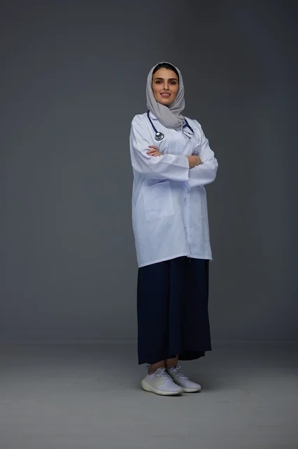 Smiling Saudi Female Doctor in White Medical Coat