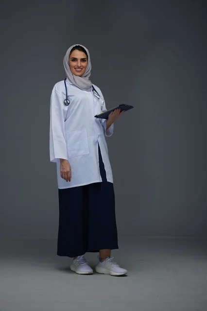 Saudi Female Doctor Holding Tablet in Medical Uniform