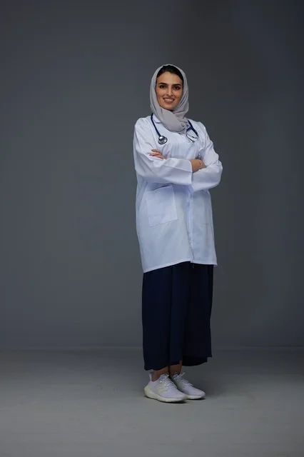 Smiling Saudi Female Doctor in White Lab Coat Studio