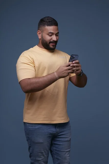 Saudi Man in Casual Clothes Using Smartphone