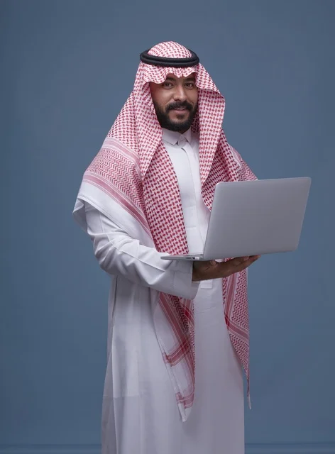 Saudi Man with Laptop in Traditional Saudi Attire