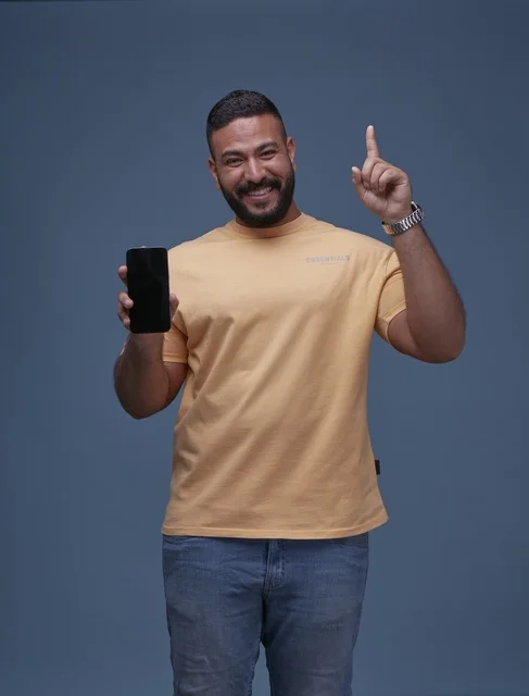 Smiling Saudi Man Holding Blank Smartphone Screen