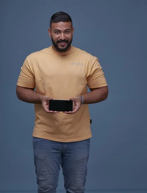 Smiling Saudi Man Holding Blank Smartphone Screen