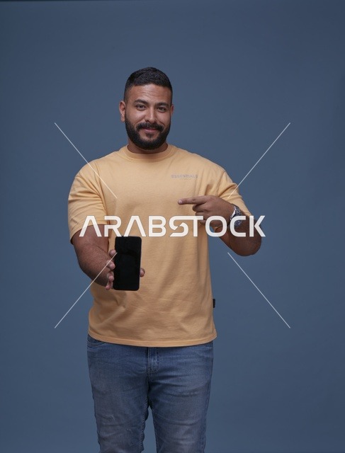 Smiling Saudi Man Pointing at Blank Smartphone Screen