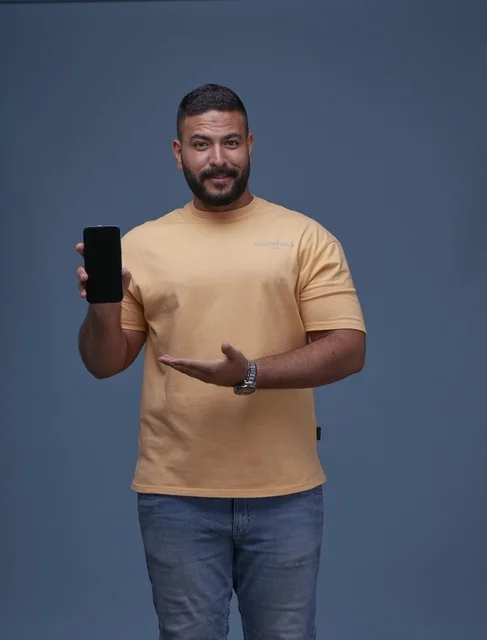 Saudi Man Holding Smartphone with Blank Screen