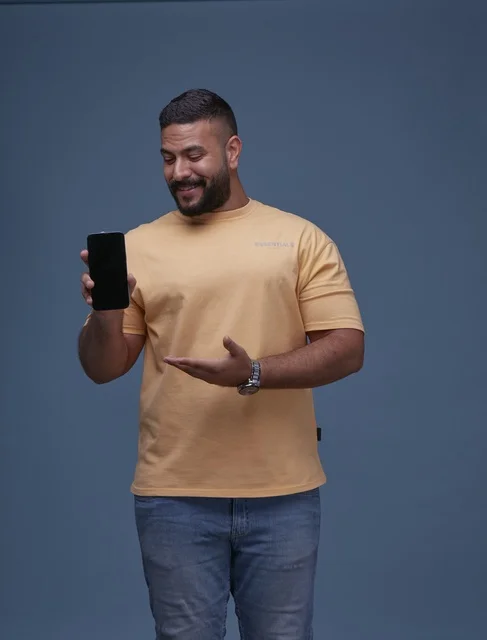 Saudi Man Holding Blank Smartphone Screen in Studio