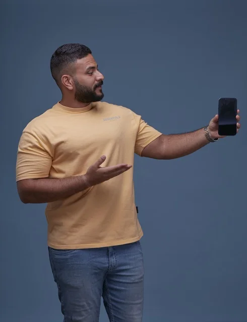 Saudi Man Holding Blank Smartphone Screen on Blue Background