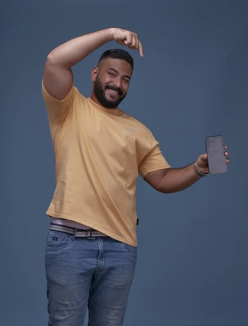 Saudi Man Pointing at Blank Smartphone Screen