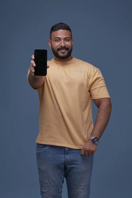Saudi Man Holding Blank Smartphone Screen in Studio