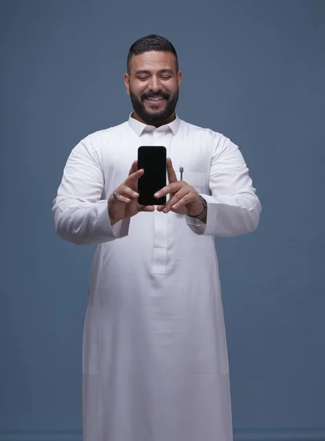 Saudi Man in Thobe Holding Smartphone Blank Screen