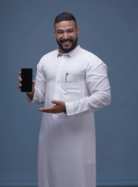 Saudi Man in White Thobe Holding Blank Smartphone