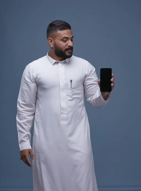Saudi Man in White Thobe Holding Blank Smartphone Screen