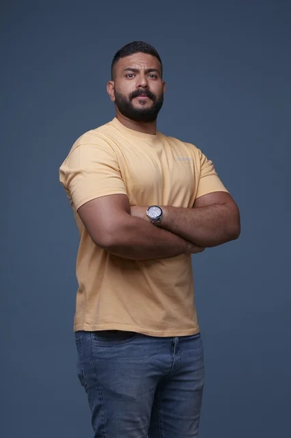 Saudi Man in Yellow T-shirt with Crossed Arms