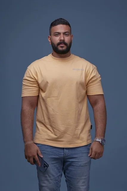 Saudi Man in Yellow Casual T-shirt with Smartphone