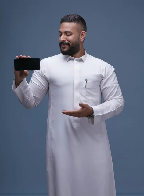 Saudi Man in White Thobe Holding Blank Smartphone Screen