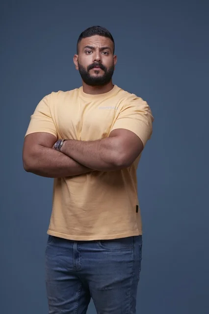 Saudi Man in Yellow T-shirt Standing with Crossed Arms
