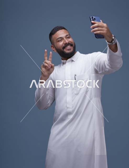 Smiling Saudi Man Taking Selfie in White Thobe