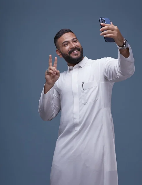 Smiling Saudi Man Taking Selfie in White Thobe