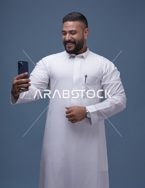 Smiling Saudi Man Taking Selfie in White Thobe