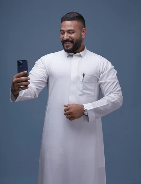 Smiling Saudi Man Taking Selfie in White Thobe