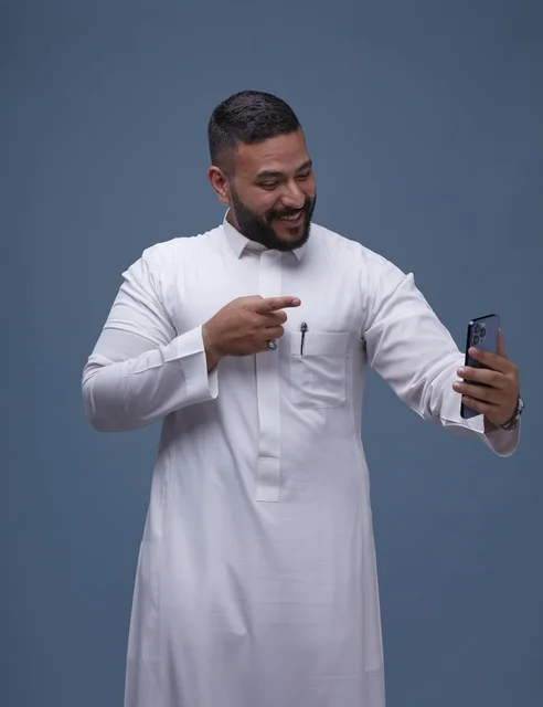 Smiling Saudi Man in Thobe Taking Selfie on Smartphone
