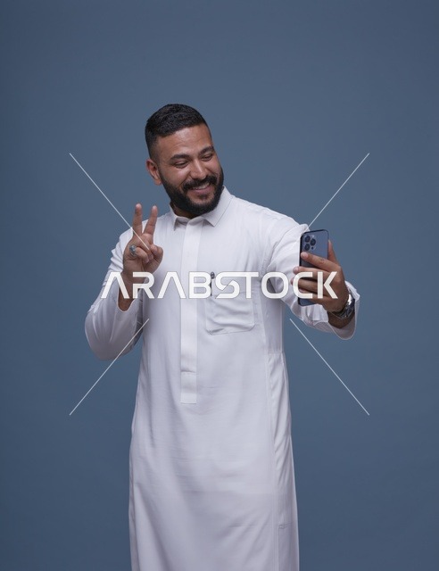 Smiling Saudi Man Taking Selfie in White Thobe