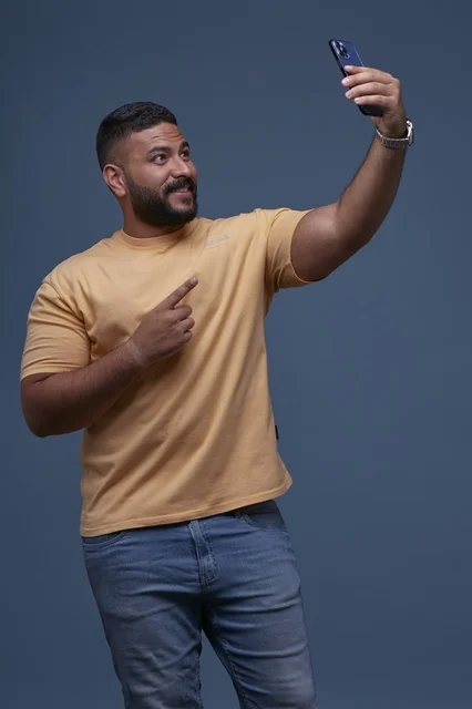 Saudi Man Taking Smartphone Selfie in Casual Clothes