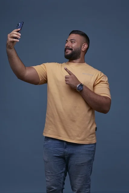 Saudi Man Taking Selfie with Smartphone in Casual Clothes