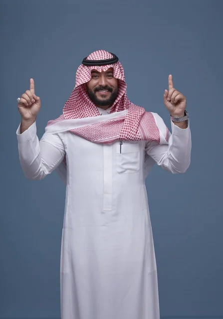 Saudi Man in Traditional Dress Pointing Up in Studio