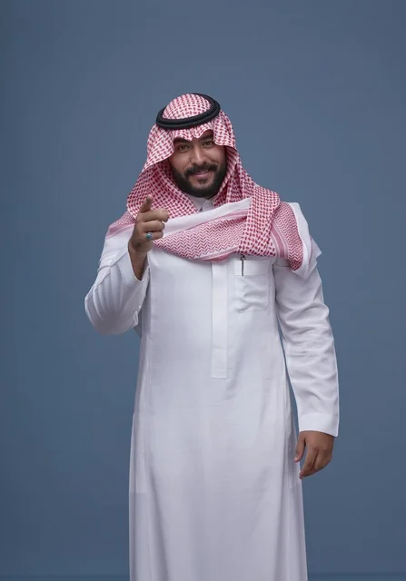 Saudi Man in Traditional Dress Pointing at Camera