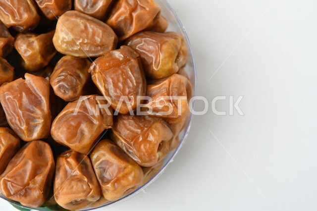 Close-up of a plate of healthy diabetes dates, a meal with a high nutritional value, Ramadan hospitality, types of healthy and delicious dates, white background