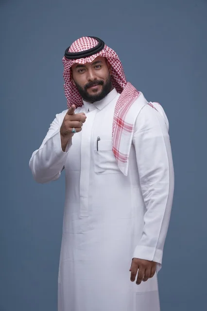 Saudi Man in Traditional Dress Pointing Studio Portrait