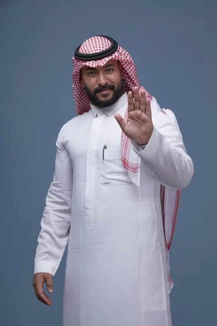 Saudi Man in Traditional Dress Making Stop Gesture