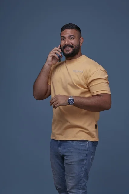 Smiling Saudi Man Talking on Smartphone in Casual Wear