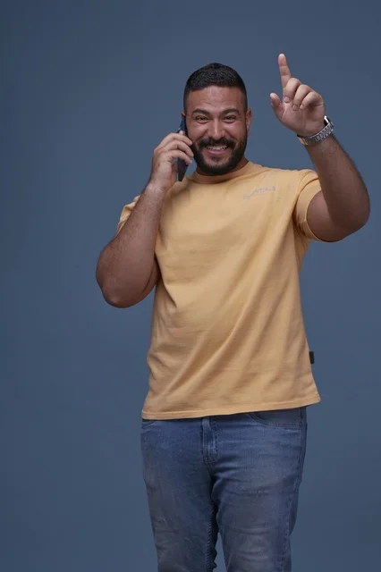 Smiling Saudi Man Talking on Smartphone in Studio
