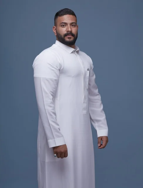 Saudi Man in White Thobe Portrait Blue Background