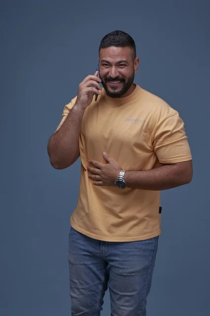Smiling Saudi Man Talking on Mobile Phone in Studio