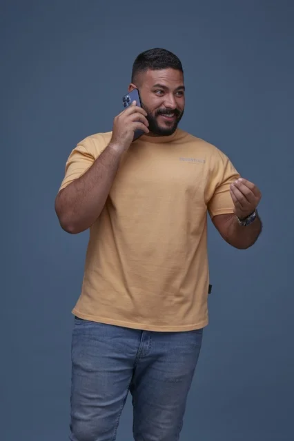 Smiling Saudi Man Talking on Mobile Phone in Studio