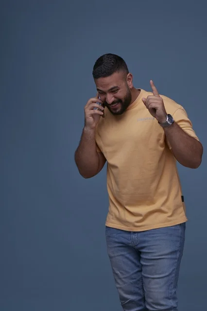 Smiling Saudi Man Talking on Mobile Phone in Studio
