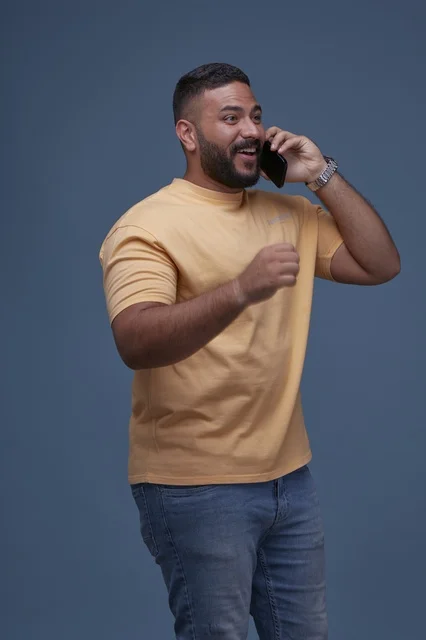 Smiling Saudi Man Talking on Smartphone in Casual Wear